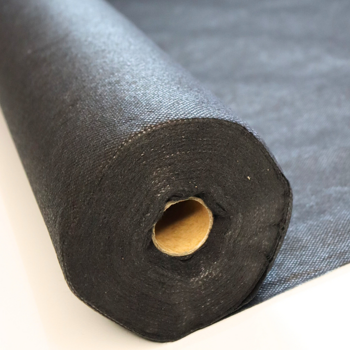 A roll of black landscape fabric used for weed control.