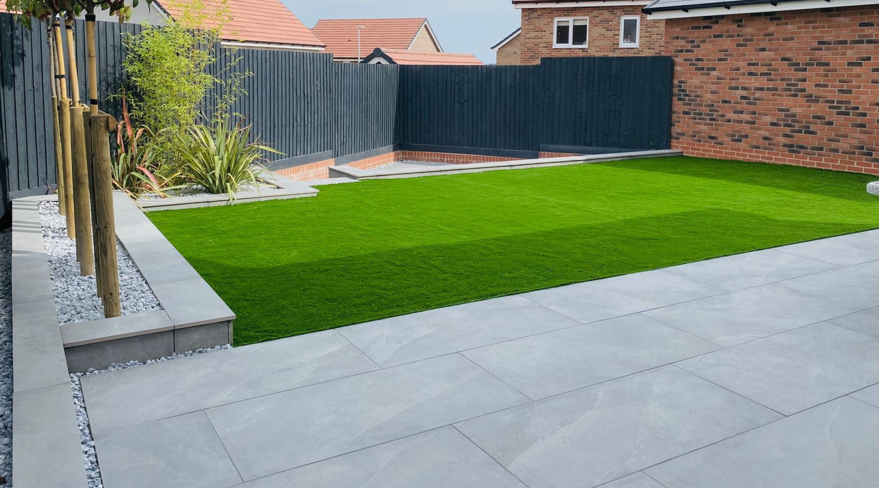 Select Living Group beautiful Artificial Grass next to Luxury Porcelain Garden Paving.