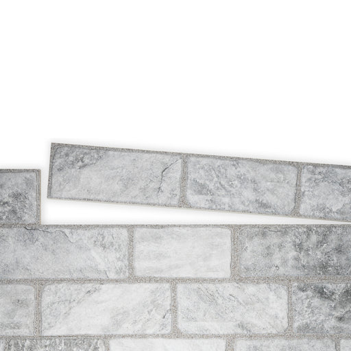 An example of a section of Cavo Porcelain Cladding. The colour is a darkish grey with a marbled effect.  One line of the tiles is separate from the main panel to show how they fit together.