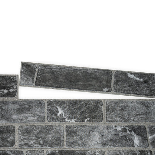 An example of a section of Monviso porcelain cladding. The colour is dark grey and the texture is marbled. On this image, there is a section removed to show how the sections fit together.