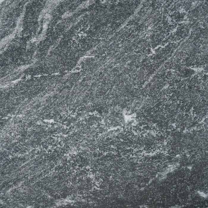 A close up of a Monviso porcelain paving slab. It has a dark grey, marbled look and texture.