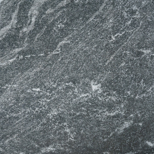 A close up of a Monviso porcelain paving slab. It has a dark grey, marbled look and texture. 