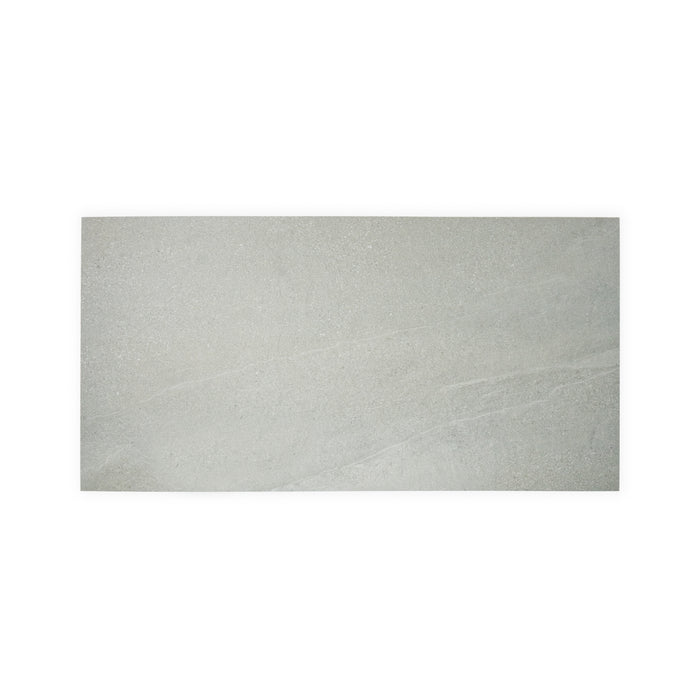 A wide shot of a single light grey Saltoro porcelain paving slab, on a white background. 