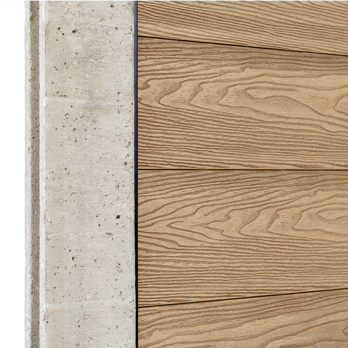 Select Living Group composite fencing angled close up product shot, Teak Flat fence panel with Concrete posts